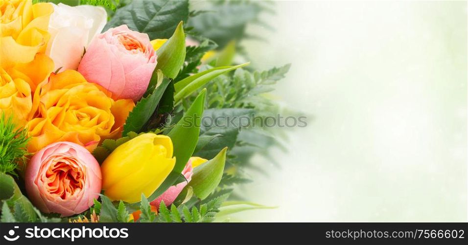 bouquet of fresh spring rose and tulip flowers on green bokeh background banner. bouquet of fresh spring flowers