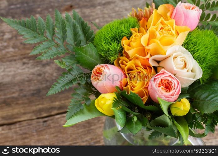 bouquet of fresh spring rose and tulip flowers on wooden table. bouquet of fresh spring flowers