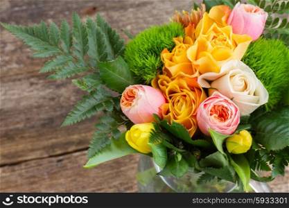 bouquet of fresh spring rose and tulip flowers on wooden table. bouquet of fresh spring flowers