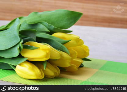 bouquet of fresh yellow tulips on table