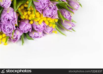 Bouquet of lilac tulips and yellow mimosas on white background, copy space, side view, closeup. March 8, February 14, birthday, Valentine?s, Mother?s, Women?s day celebration, spring concept.