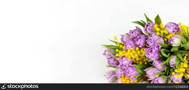 Bouquet of lilac tulips and yellow mimosas on white background, copy space, side view, closeup. March 8, February 14, birthday, Valentine?s, Mother?s, Women?s day celebration, spring concept. Banner.