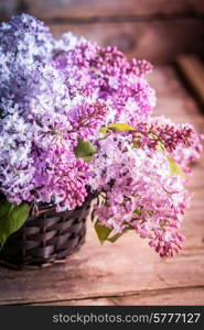 Bouquet of lilacs on wooden background