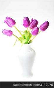 bouquet of many violet tulips in porcelain vase