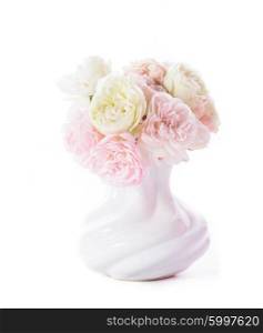 Bouquet of pink and white blooming roses in a white vase isolated on a white background. Blooming roses in vase