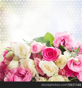 bouquet of pink and white fresh roses and eustoma flowers close up on blue bokeh background. bouquet of fresh roses