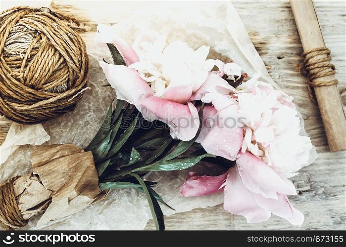 Bouquet of pink peonies on wooden table. Still Life and Gardening.