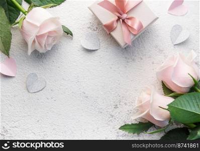 Bouquet of pink roses and gift box  on a concrete background. Valentine&rsquo;s Day