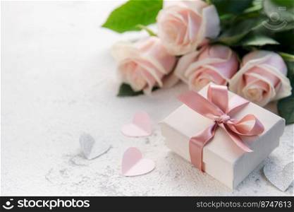 Bouquet of pink roses and gift box  on a concrete background. Valentine&rsquo;s Day