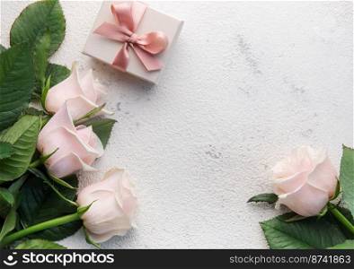 Bouquet of pink roses and gift box  on a concrete background. Valentine’s Day