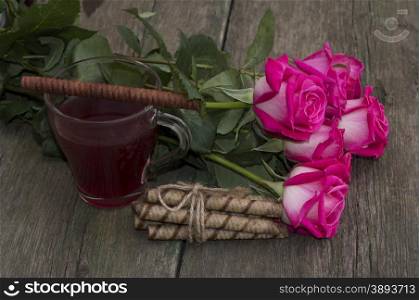 bouquet of pink roses and tea with cookies