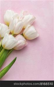 Bouquet of pink tulips on pink background. Mothers day, Valentines Day, Birthday celebration concept. Greeting card. Copy space for text, top view