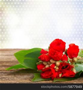 Bouquet of Poppy flowers with green leaves on wooden table border . Poppy flowers