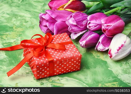 Bouquet of purple tulips and gift box. Bouquet of spring purple tulips and a box holiday gift