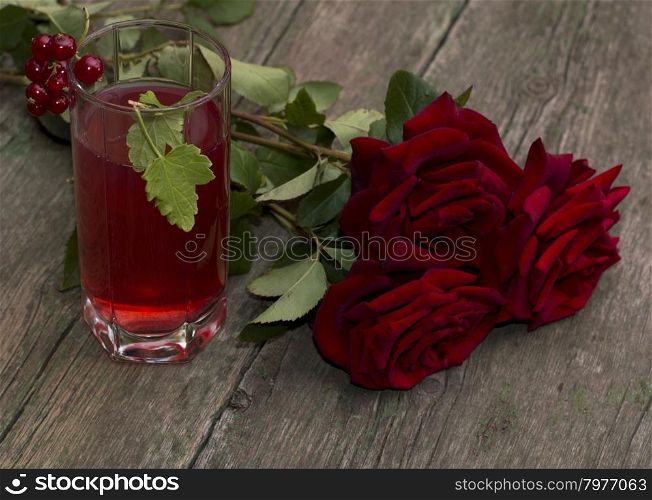 bouquet of red roses and glass with red drink, a subject drinks