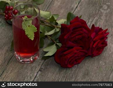 bouquet of red roses and glass with red drink, a subject drinks