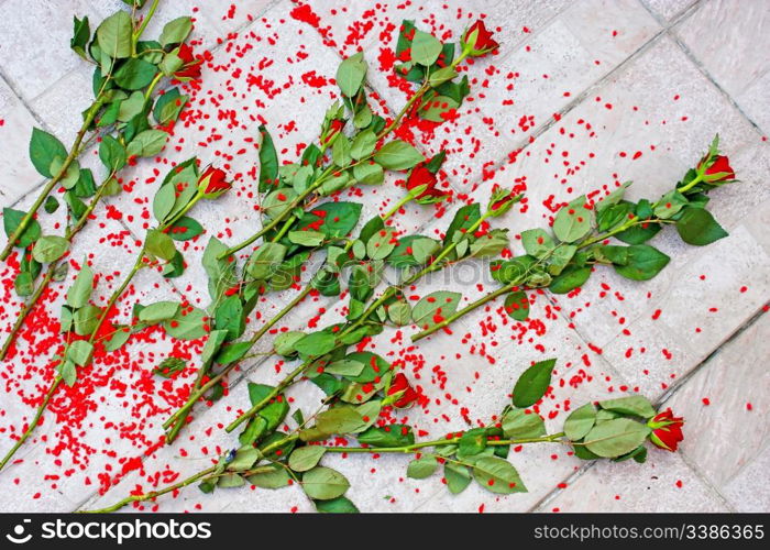 Bouquet of red roses thrown on floor