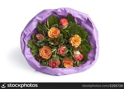 Bouquet of roses wrapped in paper on white background