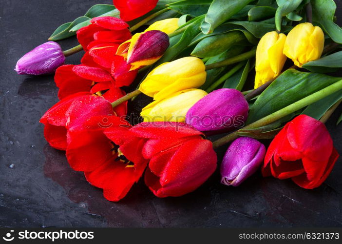 bouquet of spring tulips. bouquet of beautiful spring tulips on dark slate.Flower background.