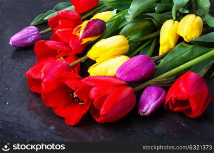bouquet of spring tulips. bouquet of beautiful spring tulips on dark slate.Flower background.