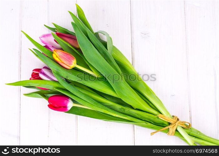 Bouquet of spring tulips on wooden table. Studio Photo. Bouquet of spring tulips on wooden table
