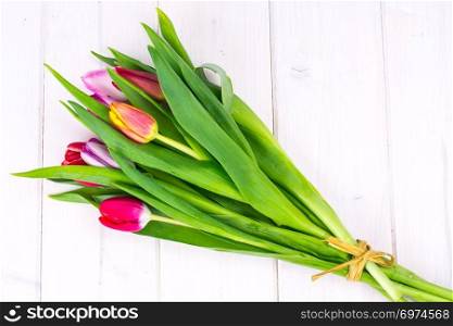 Bouquet of spring tulips on wooden table. Studio Photo. Bouquet of spring tulips on wooden table