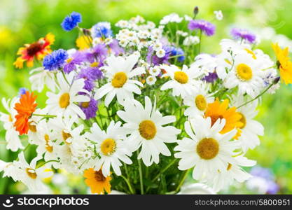 bouquet of summer flowers on green background