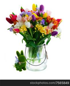 Bouquet of tulips and freesias in vase with easter rabbit isolated on white background. fresh tulips flowers