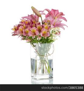 Bouquet of various flowers in glass jar on white background.