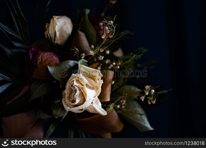 bouquet of vintage dry roses on dark background