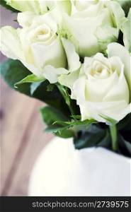 Bouquet of white roses in vase on table