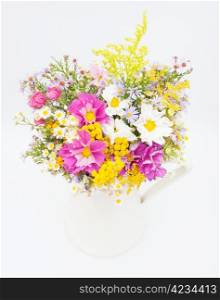 Bouquet of Wild Summer Flowers in White Pitcher on White Background
