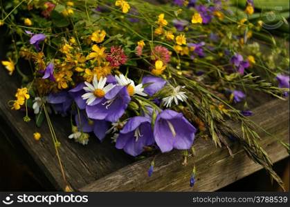 Bouquet of wildflowers on wooden boards