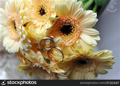 bouquet of yellow flowers and wedding gold rings