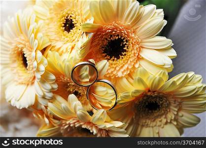 bouquet of yellow flowers and wedding gold rings
