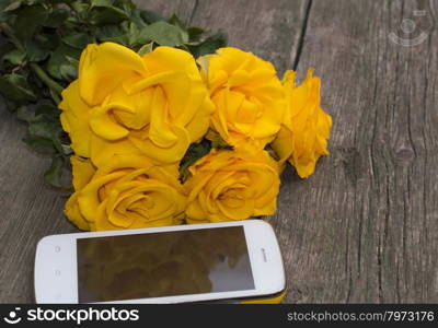 bouquet of yellow roses and their reflection in the phone