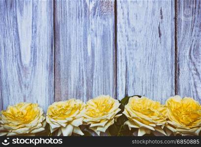 Bouquet of yellow roses on a white wooden background, vintage toning