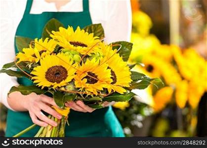 Bouquet sunflowers flower shop female florist holding