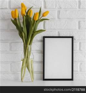 bouquet tulips transparent vase with empty frame