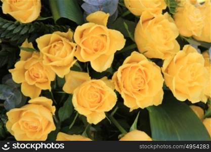 Bouquet with yellow roses and some green decoration