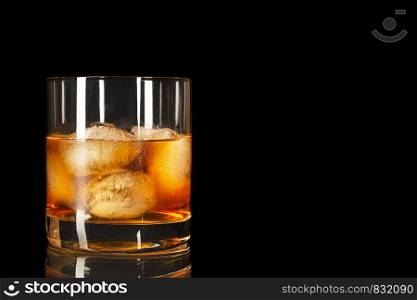 Bourbon snifter whiskey scotch glass on the black background, copy space