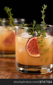 Bourbon Sour cocktail with fig spices, lemon juice and syrup. Easy to make but so delicious. Garnish with figs and thyme.