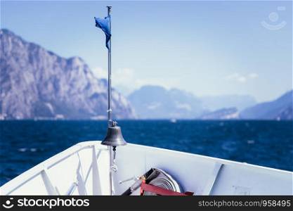Bow of a boat on a boat tour. Blue water and mountain range, Lago di Garda, Italy