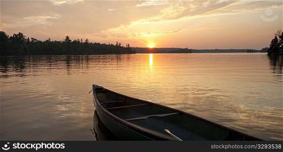 Bow of a canoe with the sunset in the horizon at Lake of the Woods, Ontario