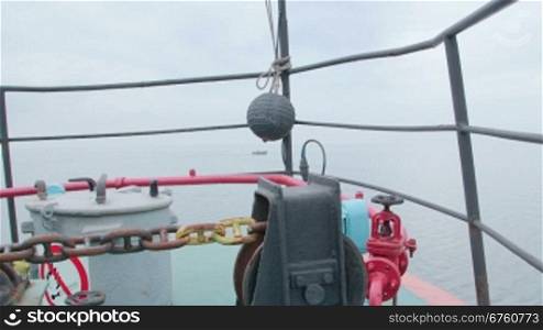 Bow of commercial fishing boat in the misty sea