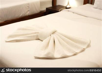 bow shaped of towel on the bed