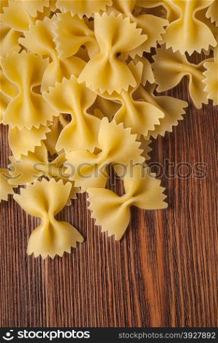 bow tie pasta on wooden background close up