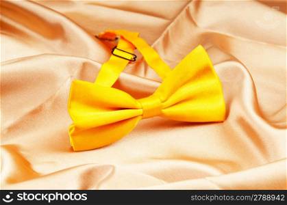 Bow ties on the bright satin background