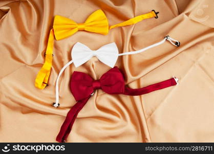 Bow ties on the bright satin background