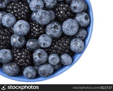 Bowl full of fresh blackberries and blueberries on white background.